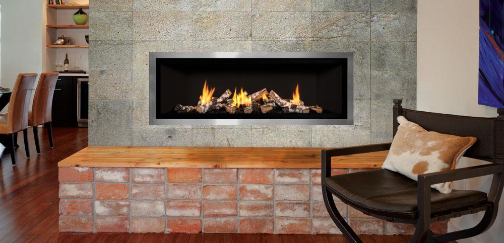 Modern gas insert with hearth made of wood and bricks - surround is tile with chair and cow hide pillow 